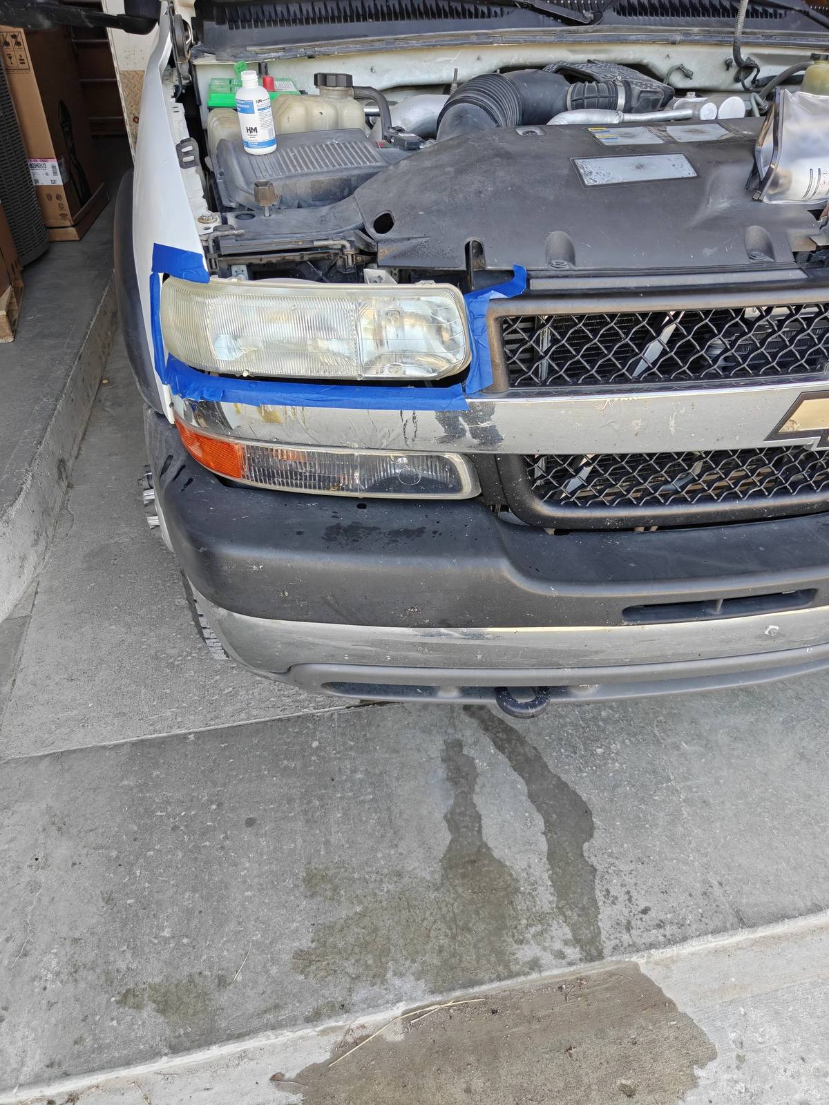 Headlight restoration in progress on a Chevy van